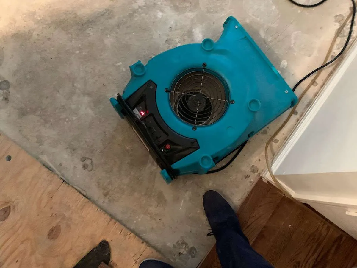 Air mover drying subfloor during Commercial Water Damage Restoration in Hickory